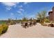 Stunning pool and patio area with beautiful desert views, lush landscaping, and comfortable lounge chairs at 9161 E Superstition Mountain Dr, Gold Canyon, AZ 85118
