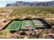Aerial view of tennis courts surrounded by natural desert vegetation, showcasing recreational amenities at 9161 E Superstition Mountain Dr, Gold Canyon, AZ 85118