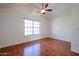 Bedroom with hardwood floors, white walls, and a large window at 921 W University Dr # 1099, Mesa, AZ 85201