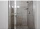 Tiled shower with glass doors and a built-in shelf at 921 W University Dr # 1099, Mesa, AZ 85201