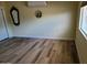 Simple bedroom with laminate flooring, a bright window, and minimalist decor at 10309 W Twin Oaks Dr, Sun City, AZ 85351