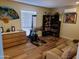 Bedroom area with exercise equipment, dresser, shelving unit, and comfortable seating at 10309 W Twin Oaks Dr, Sun City, AZ 85351