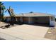Exterior showcasing a desert-style landscape with stone facade and a covered carport at 10309 W Twin Oaks Dr, Sun City, AZ 85351
