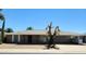 Charming single-story home showcasing desert landscaping, a stone facade, and a covered carport at 10309 W Twin Oaks Dr, Sun City, AZ 85351