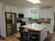 Modern kitchen boasting white cabinets, stainless steel appliances, and a center island with granite countertops at 10309 W Twin Oaks Dr, Sun City, AZ 85351