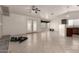 Bright and airy living room with tile flooring, ceiling fan, and access to the backyard through French doors at 10312 W Mazatlan Dr, Arizona City, AZ 85123