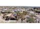 Aerial shot of a desert home with solar panels, spacious backyard, and surrounding desert landscape at 10718 E Fenimore Rd, Mesa, AZ 85207