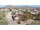 Desert home featuring solar panels, gated entry, and drought-tolerant landscaping at 10718 E Fenimore Rd, Mesa, AZ 85207