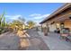 Expansive backyard with a covered patio, BBQ grill, fountain and mature desert landscaping at 10718 E Fenimore Rd, Mesa, AZ 85207
