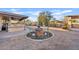 Backyard with a fountain, covered patio, desert landscaping and ample space at 10718 E Fenimore Rd, Mesa, AZ 85207