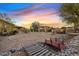 Expansive backyard with desert landscaping, pergola, bridge, and walking paths offers outdoor living at 10718 E Fenimore Rd, Mesa, AZ 85207