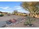 Expansive backyard featuring a bridge over a decorative rock bed and desert landscaping at 10718 E Fenimore Rd, Mesa, AZ 85207