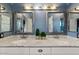 Bathroom with a double sink vanity, framed mirrors, decorative plants and ample counter space at 10718 E Fenimore Rd, Mesa, AZ 85207