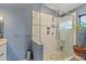 Modern bathroom featuring a glass-enclosed shower with tile surround and a vanity at 10718 E Fenimore Rd, Mesa, AZ 85207