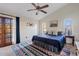 Bedroom with a ceiling fan, vaulted ceiling, colorful rug and access to an outdoor balcony at 10718 E Fenimore Rd, Mesa, AZ 85207