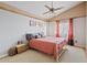 Bright bedroom with vaulted ceiling, warm lighting, and a comfortable bed at 10718 E Fenimore Rd, Mesa, AZ 85207