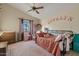 Cozy bedroom with vaulted ceiling, pink accents, and a comfortable bed at 10718 E Fenimore Rd, Mesa, AZ 85207