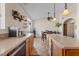 Bright kitchen featuring stainless steel appliances, an island with a light countertop and tile flooring at 10718 E Fenimore Rd, Mesa, AZ 85207