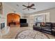 Spacious living room with a Southwestern style, fireplace, and a large bay window at 10718 E Fenimore Rd, Mesa, AZ 85207