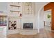 Cozy living room with a traditional fireplace and a glimpse into an adjoining space at 10718 E Fenimore Rd, Mesa, AZ 85207