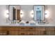 Bathroom featuring a double sink vanity with oak cabinets and modern fixtures at 11199 E Prospect Point Dr, Scottsdale, AZ 85262