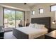 Inviting bedroom with a glass sliding door to an outdoor patio and desert landscape at 11199 E Prospect Point Dr, Scottsdale, AZ 85262