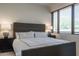 Cozy bedroom with a platform bed, nightstands, and a window with wood blinds at 11199 E Prospect Point Dr, Scottsdale, AZ 85262