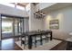 Dining room with a modern chandelier and a large sliding glass door at 11199 E Prospect Point Dr, Scottsdale, AZ 85262