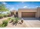 Desert home with a large two car garage and desert landscaping at 11199 E Prospect Point Dr, Scottsdale, AZ 85262