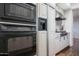 Modern kitchen featuring stainless steel appliances, sleek cabinetry, and wood flooring at 11199 E Prospect Point Dr, Scottsdale, AZ 85262