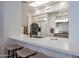 Kitchen area with barstool seating and featuring stainless steel appliances and white cabinetry at 11199 E Prospect Point Dr, Scottsdale, AZ 85262