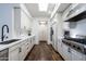 Spacious kitchen with stainless steel appliances, white cabinets, and dark hardwood floors at 11199 E Prospect Point Dr, Scottsdale, AZ 85262