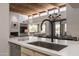 Kitchen view featuring a large island, modern faucet and decor with living space in background at 11199 E Prospect Point Dr, Scottsdale, AZ 85262