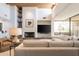 Living room with a fireplace, comfortable furniture, and exposed beam ceiling at 11199 E Prospect Point Dr, Scottsdale, AZ 85262