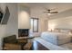 Bright bedroom boasts a fireplace, ceiling fan and a sitting area at 11199 E Prospect Point Dr, Scottsdale, AZ 85262