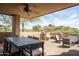 Covered patio featuring a dining table and chairs with serene desert views for outdoor entertaining at 11199 E Prospect Point Dr, Scottsdale, AZ 85262