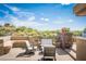 Outdoor lounge area featuring built-in seating and desert views at 11199 E Prospect Point Dr, Scottsdale, AZ 85262