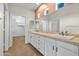 Bathroom with dual sinks, framed mirrors, and ample cabinet space at 11500 E Cochise Dr # 2067, Scottsdale, AZ 85259