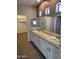 Primary bathroom featuring dual sinks, a large mirror, and a neutral color palette at 11500 E Cochise Dr # 2067, Scottsdale, AZ 85259