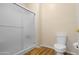 Bright bathroom features a shower with glass doors, toilet, and wood-look flooring at 11500 E Cochise Dr # 2067, Scottsdale, AZ 85259