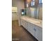 Bathroom featuring double sinks, a large mirror, and ample cabinet space at 11500 E Cochise Dr # 2067, Scottsdale, AZ 85259
