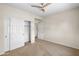 Bedroom with carpet, a ceiling fan, and mirrored sliding closet doors at 11500 E Cochise Dr # 2067, Scottsdale, AZ 85259