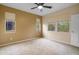Bright bedroom with neutral walls, carpet, multiple windows, and a ceiling fan at 11500 E Cochise Dr # 2067, Scottsdale, AZ 85259