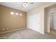 Cozy bedroom features carpeted floors, ceiling fan, and closet with sliding doors at 11500 E Cochise Dr # 2067, Scottsdale, AZ 85259