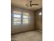 Bedroom with a ceiling fan and large windows providing natural light and neighborhood views at 11500 E Cochise Dr # 2067, Scottsdale, AZ 85259