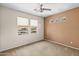 Bedroom with fan, carpet, and multiple windows letting in natural light at 11500 E Cochise Dr # 2067, Scottsdale, AZ 85259