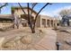 Stunning community clubhouse entrance featuring stone landscaping and paved walkway at 11500 E Cochise Dr # 2067, Scottsdale, AZ 85259
