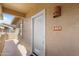 Inviting front entrance with a white door and stylish light fixture and visible house number at 11500 E Cochise Dr # 2067, Scottsdale, AZ 85259