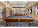 Spacious game room featuring multiple pool tables and stylish lighting fixtures at 11500 E Cochise Dr # 2067, Scottsdale, AZ 85259