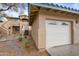 Exterior view of a well-maintained garage with neutral paint and decorative details at 11500 E Cochise Dr # 2067, Scottsdale, AZ 85259